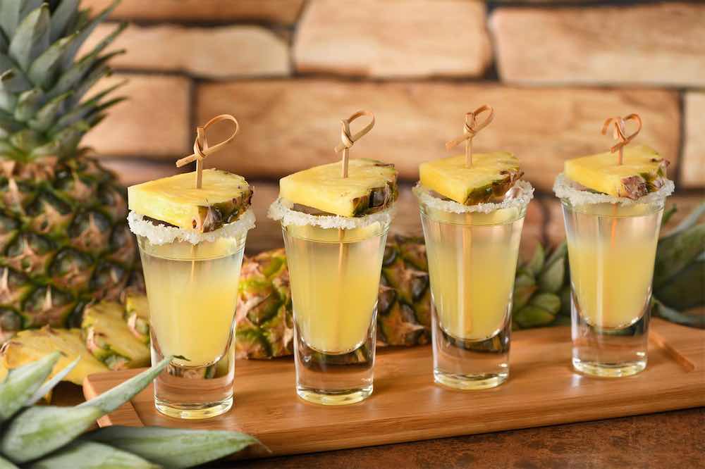 Shots of Tequila with a pineapple garnish