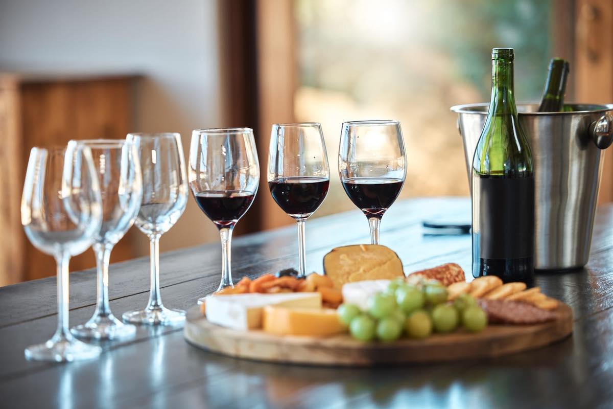 A plate of cheese, crackers, cold cuts and grapes for a wine-tasting themed bachelorette party